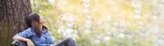 Women resting on tree enjoying outdoors